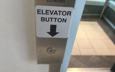 Bad planning and design in action: check out these duelling buttons and signs at Oakridge Mall